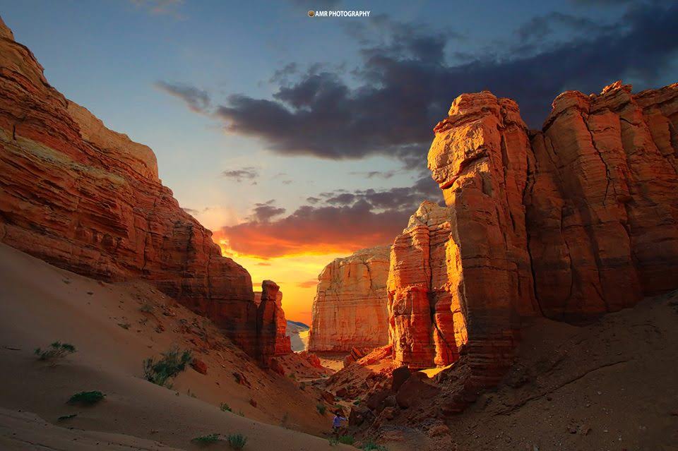an aerial view of a desert with rocks and sand