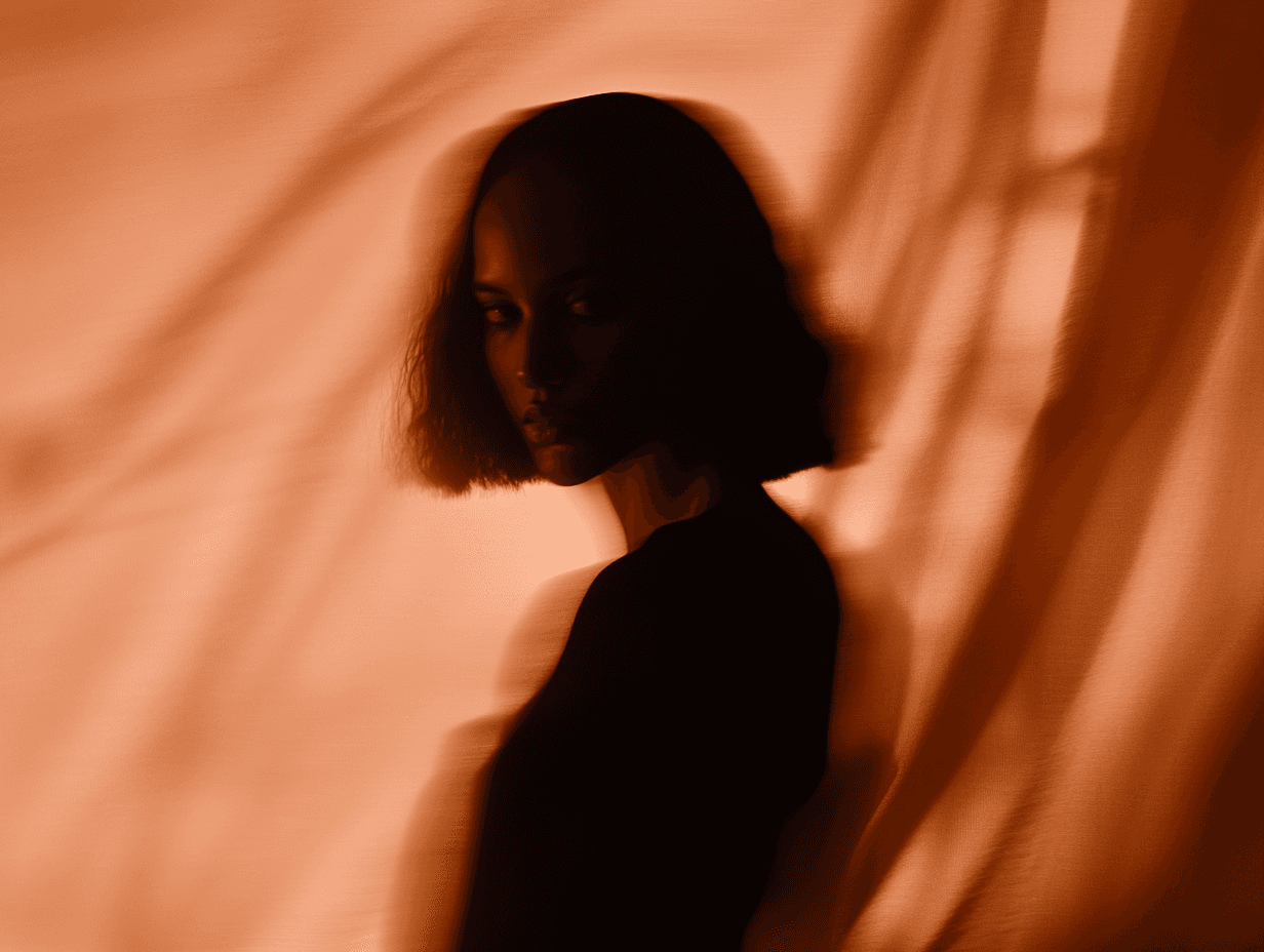 Portrait shot of a woman against a dark brown silk background