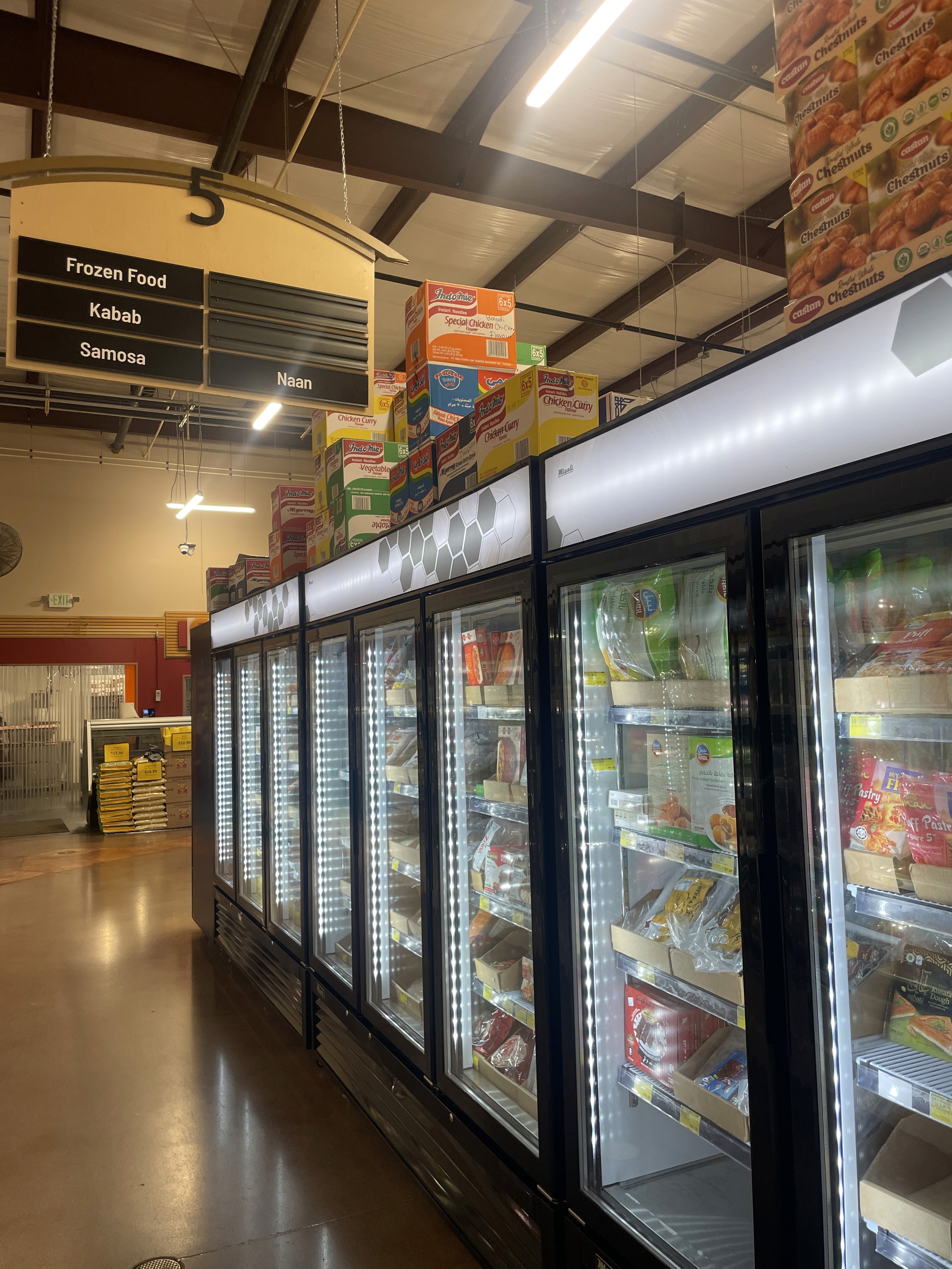 Freezers stocked with frozen snacks and entrees at International Food Market Orlando.