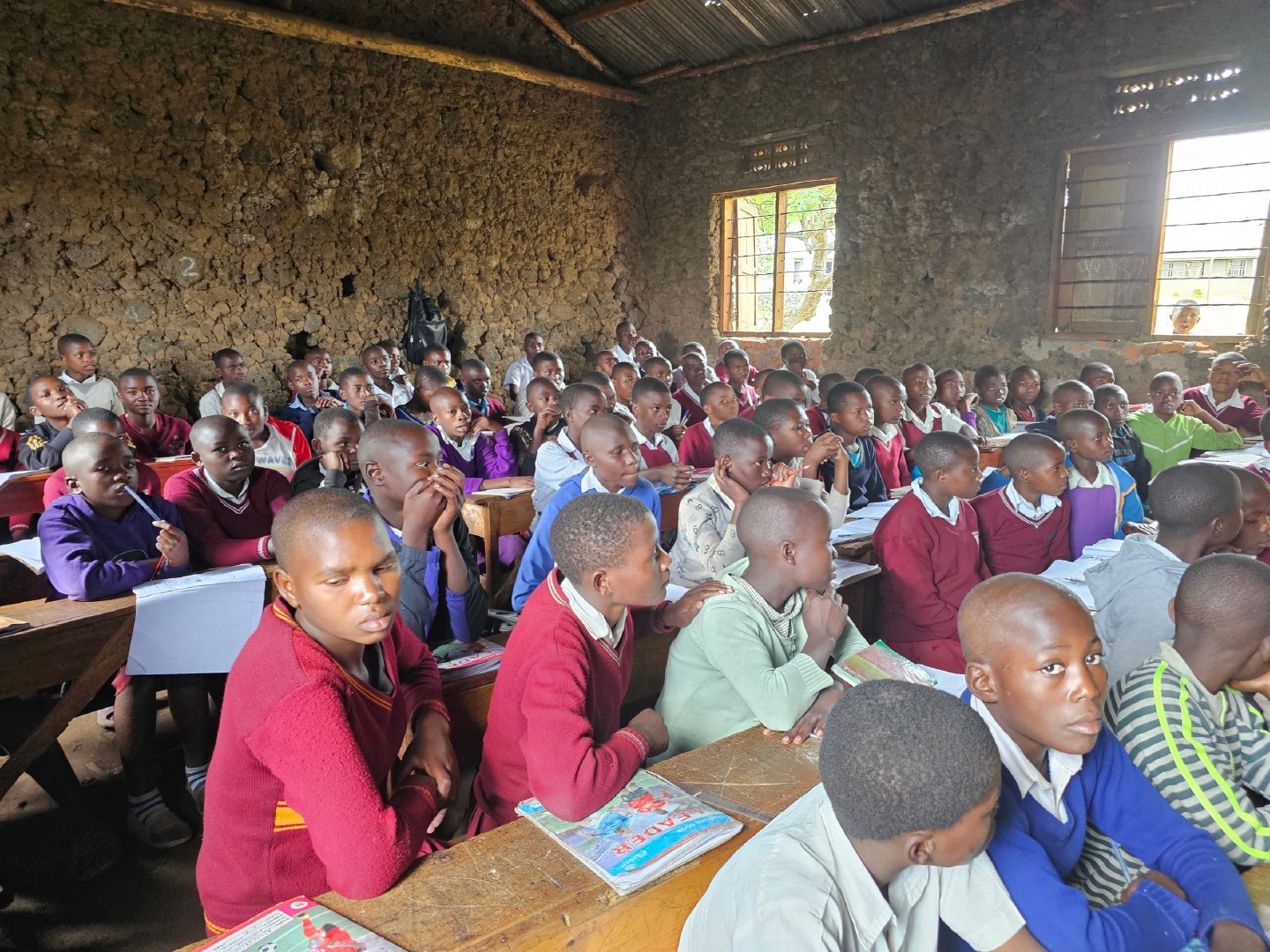 a group of children sitting on steps in front of a building