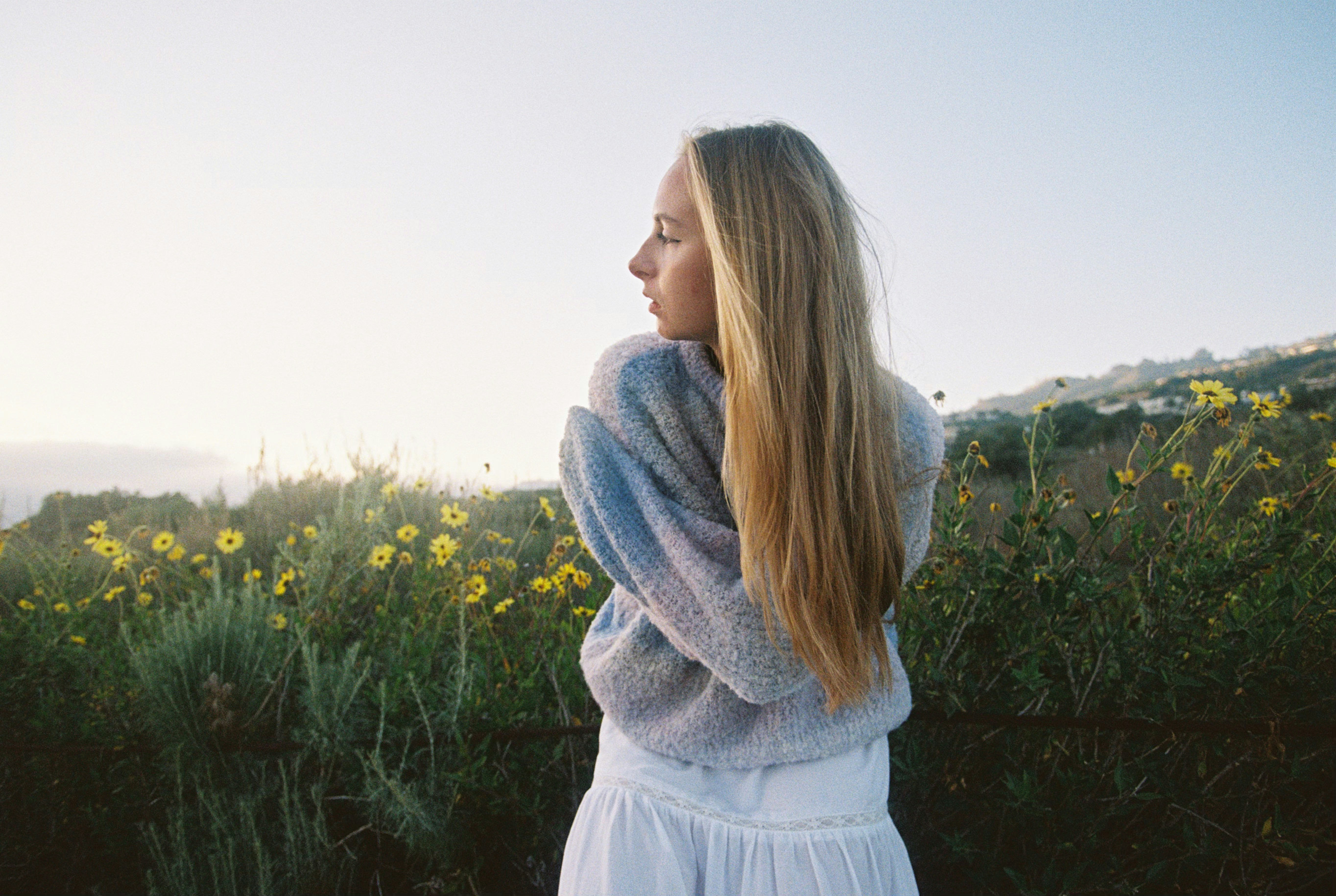 Young woman in a field of yellow flowers