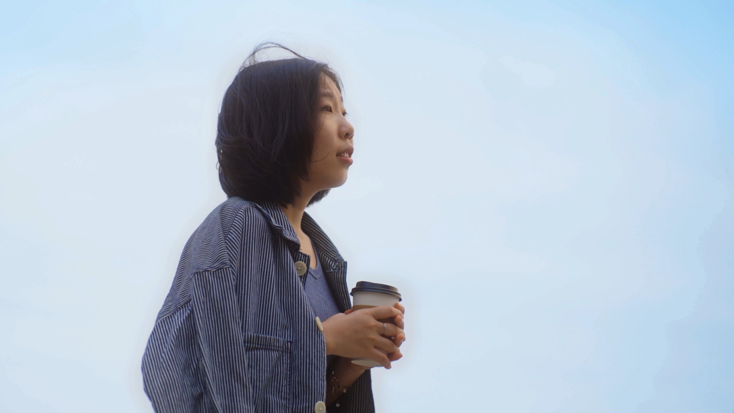 the sister holding her hot chocolate bought by her brother looking at her brother