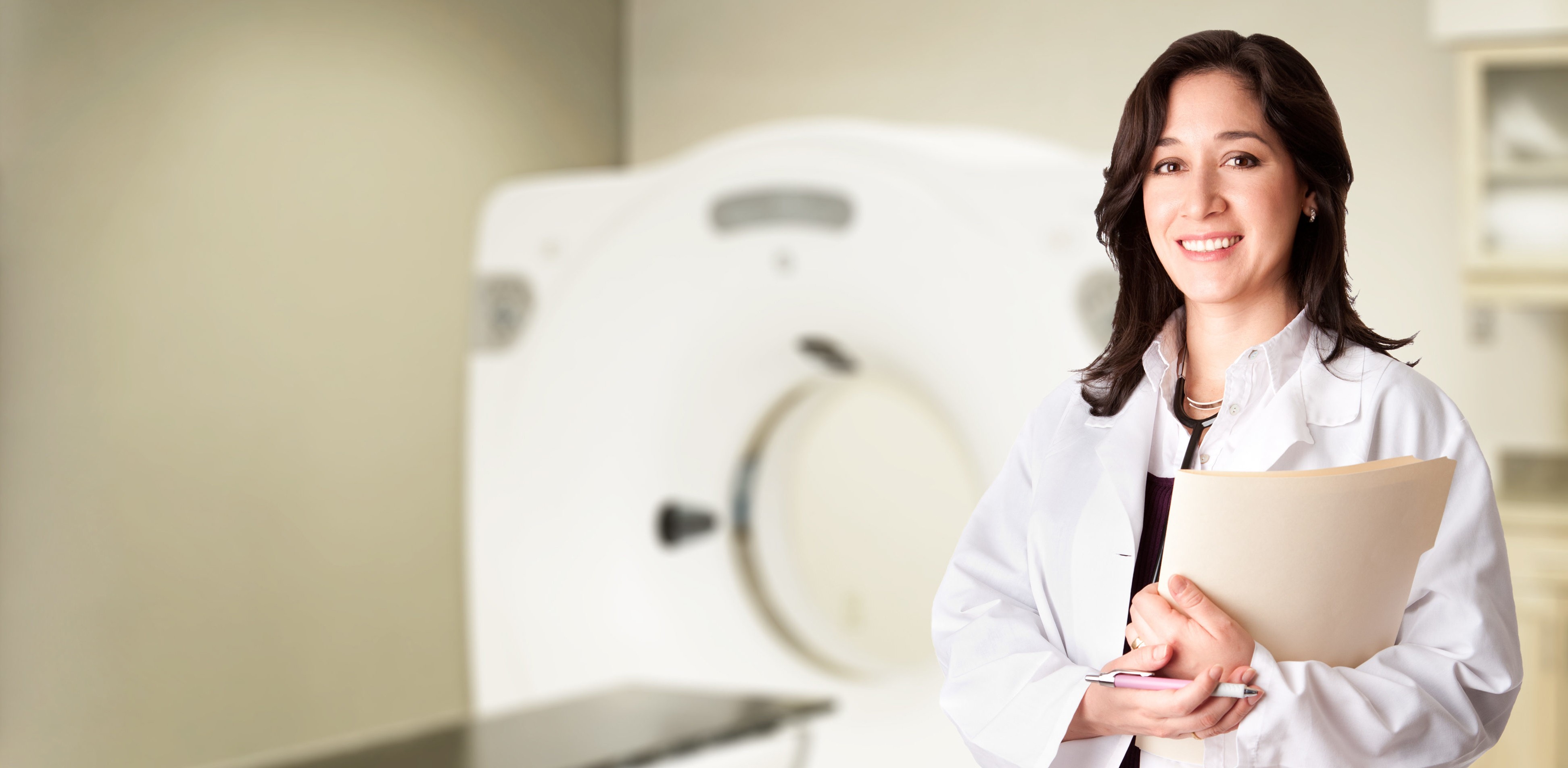 woman in blue tank top standing beside white wall