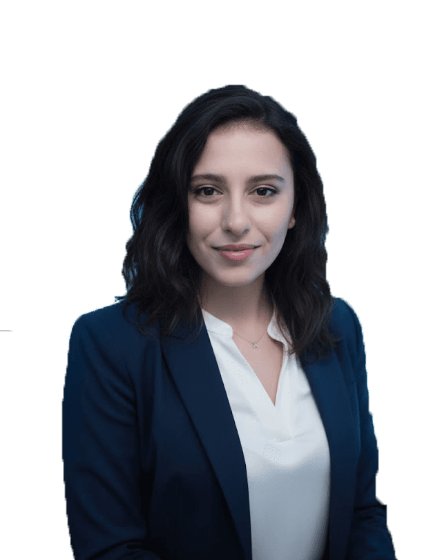 Professional woman in a suit standing in an office setting.