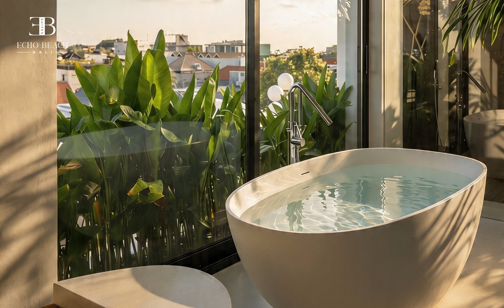 Close-up view of the modern stone bathroom vanity with a white vessel sink, wall-mounted faucet, and illuminated mirror at the Echo Beach Suite in Canggu, Bali.