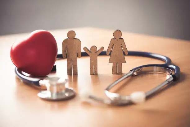 Wooden Family surounded by stethoscope