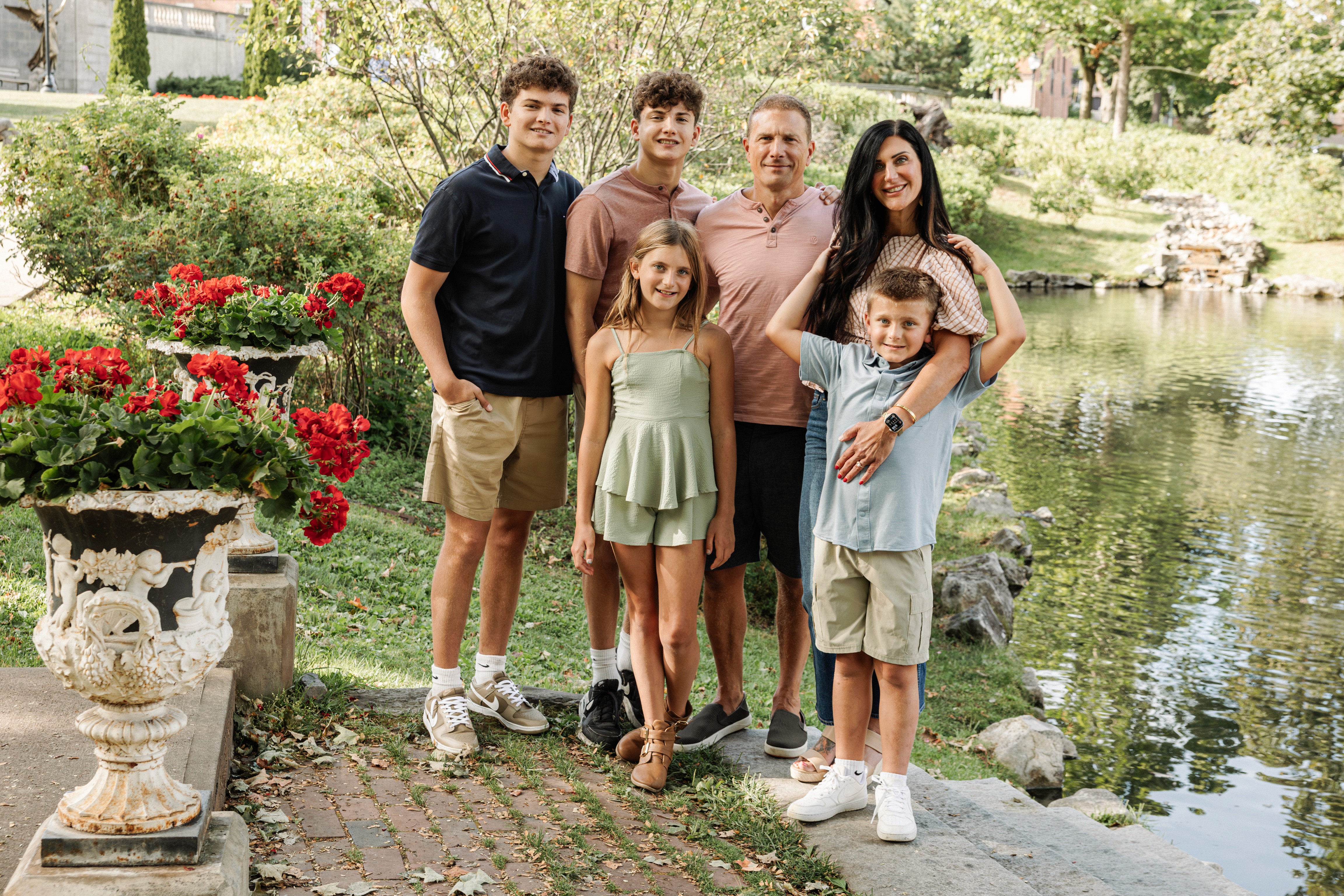 6:13 PMNewly engaged couple sitting on a stoop in the West Village, NYC bathed in warm golden hour light — romantic, candid golden hour engagement photography by Lizz Spano Photography, New York City engagement photographer.