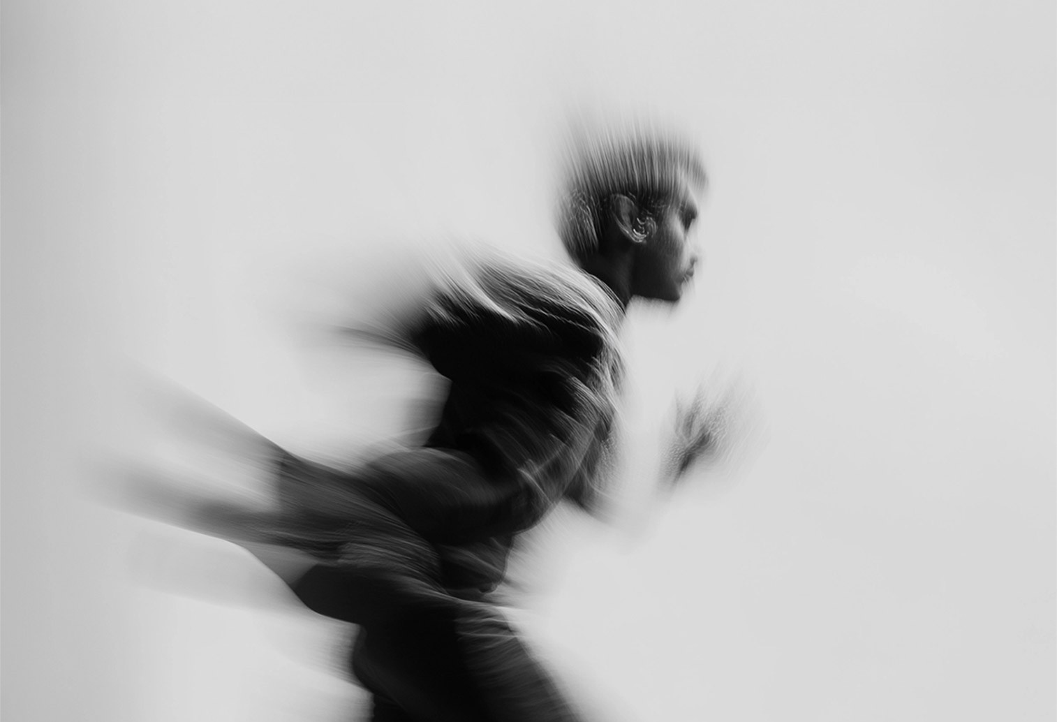 Photo of a man running with a blur effect in black and white