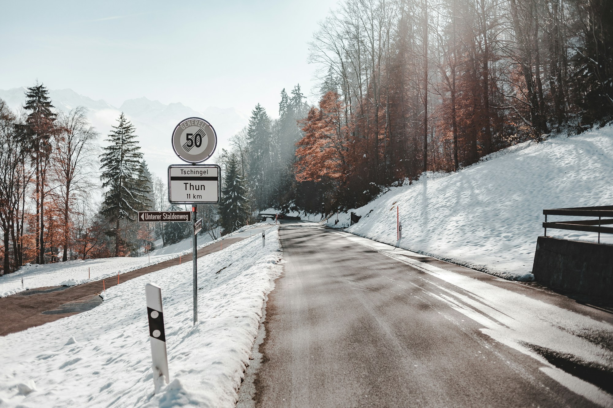 Snow-covered alpine road leading through a mountain landscape near Verbier