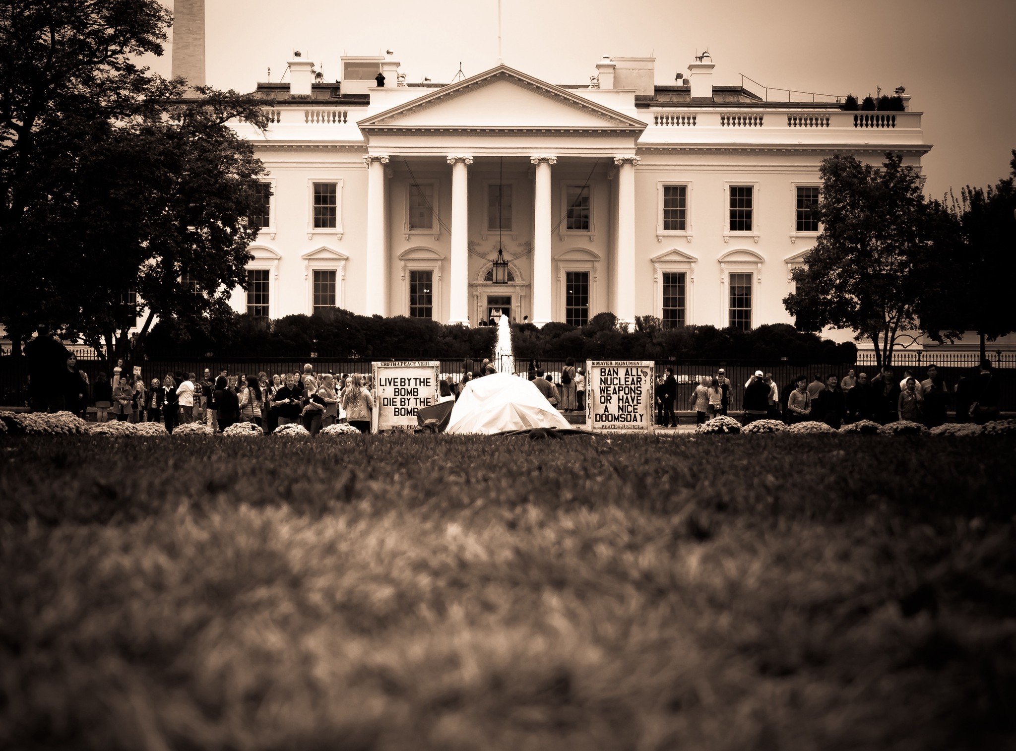 The White House captured with a person walking on the lawn in the foreground.