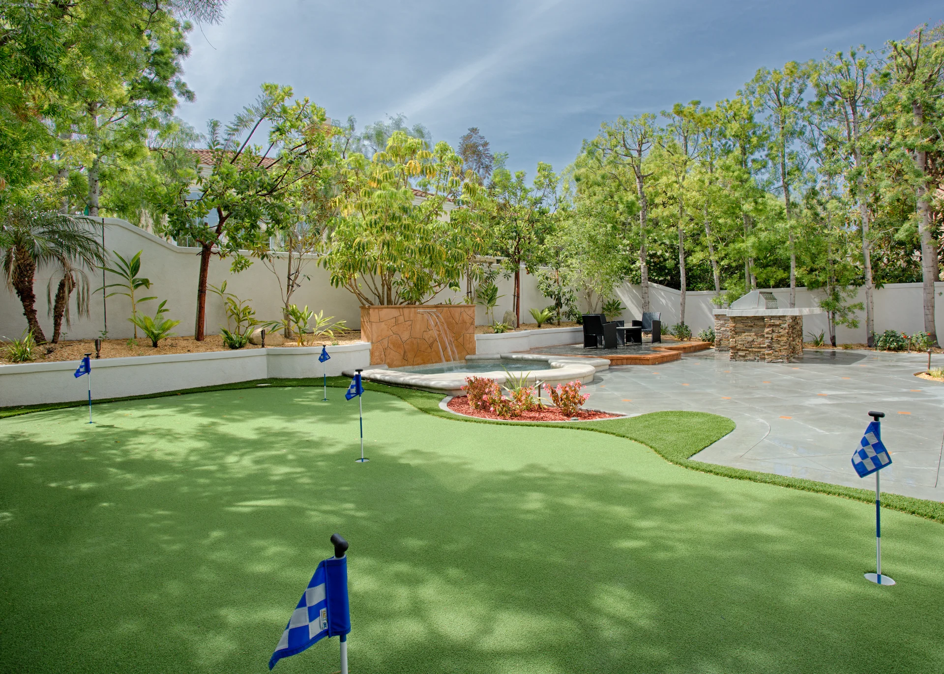 View from angle 1 of the putting green and outdoor kitchen, showcasing the perfect blend of recreation and entertainment in the Harbor Cove remodel.