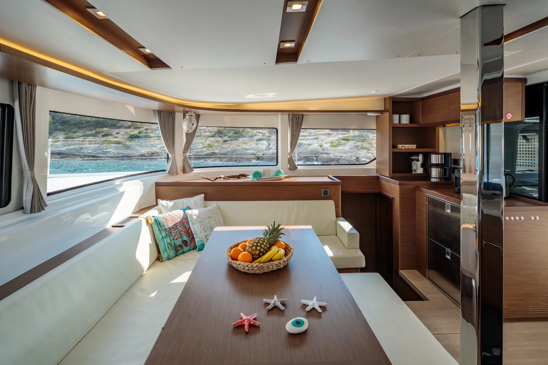 White Rock 36 speedboat with captain at helm cruising calm blue waters near Paros coastline with hills in background.
