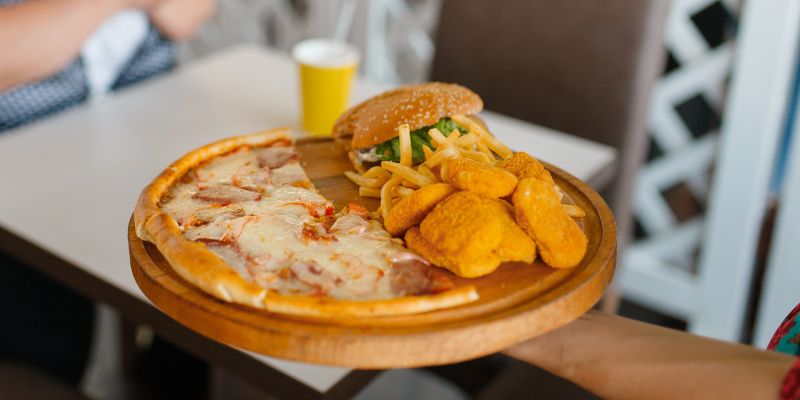 A quick-service restaurant staff serving an order