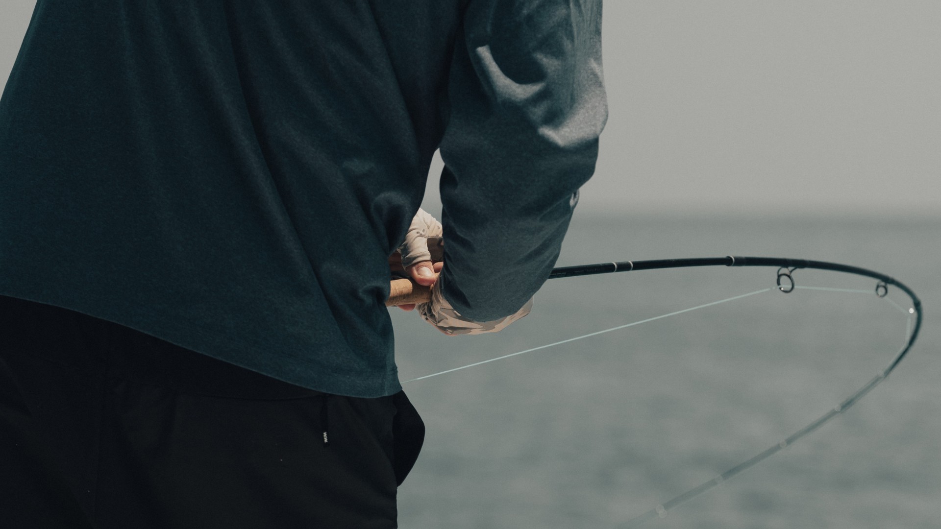 Angler holding a bent fly fishing rod