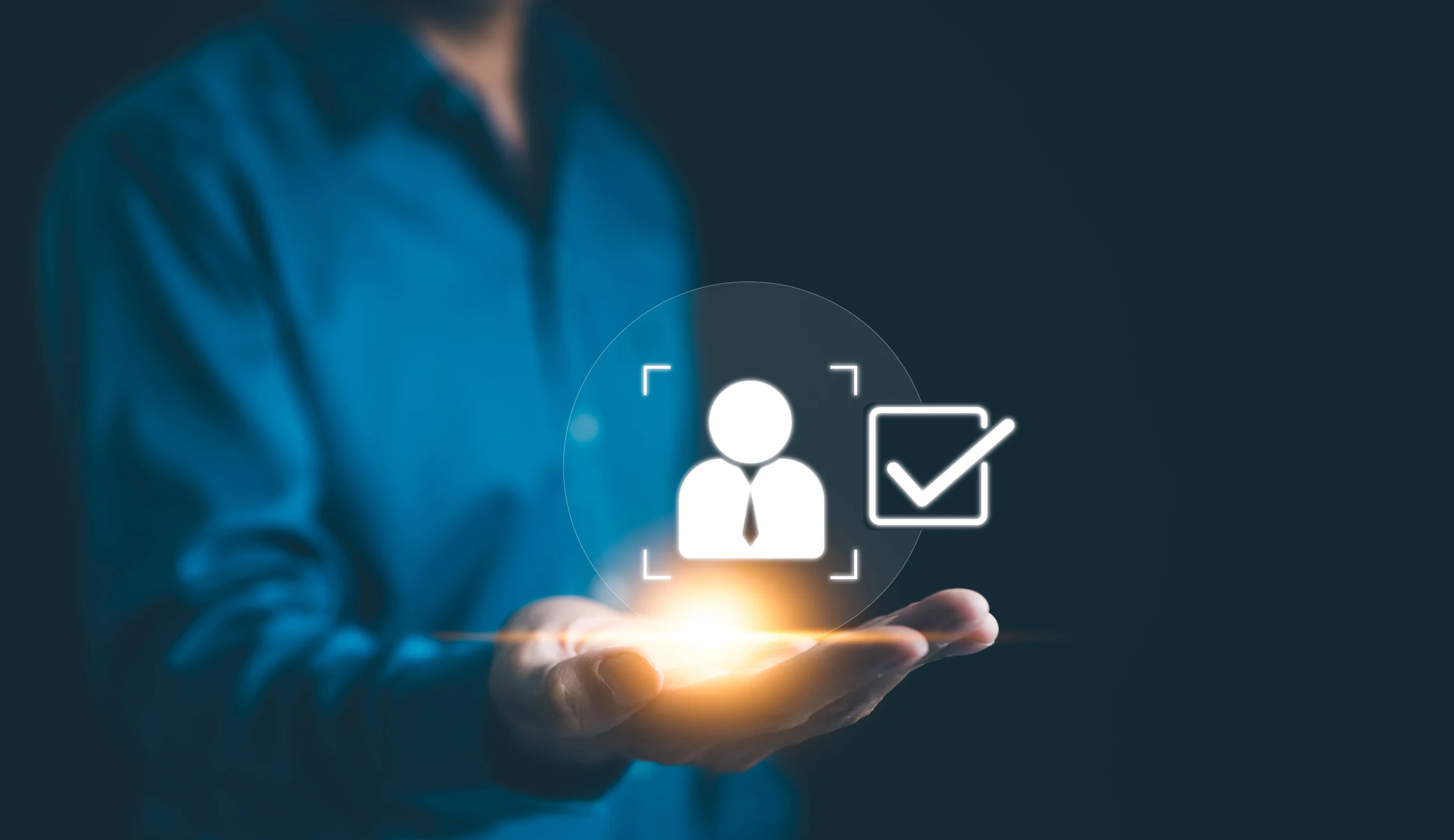 A person walks in front of large stone arches with dark doors, flanked by tall columns, in a historic building.
