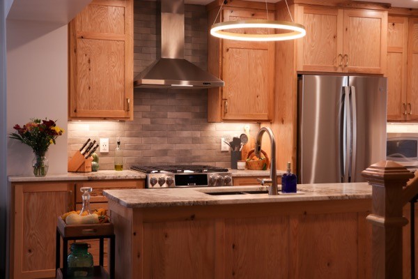 Kitchen remodel with natural wood cabinets and slate backsplash