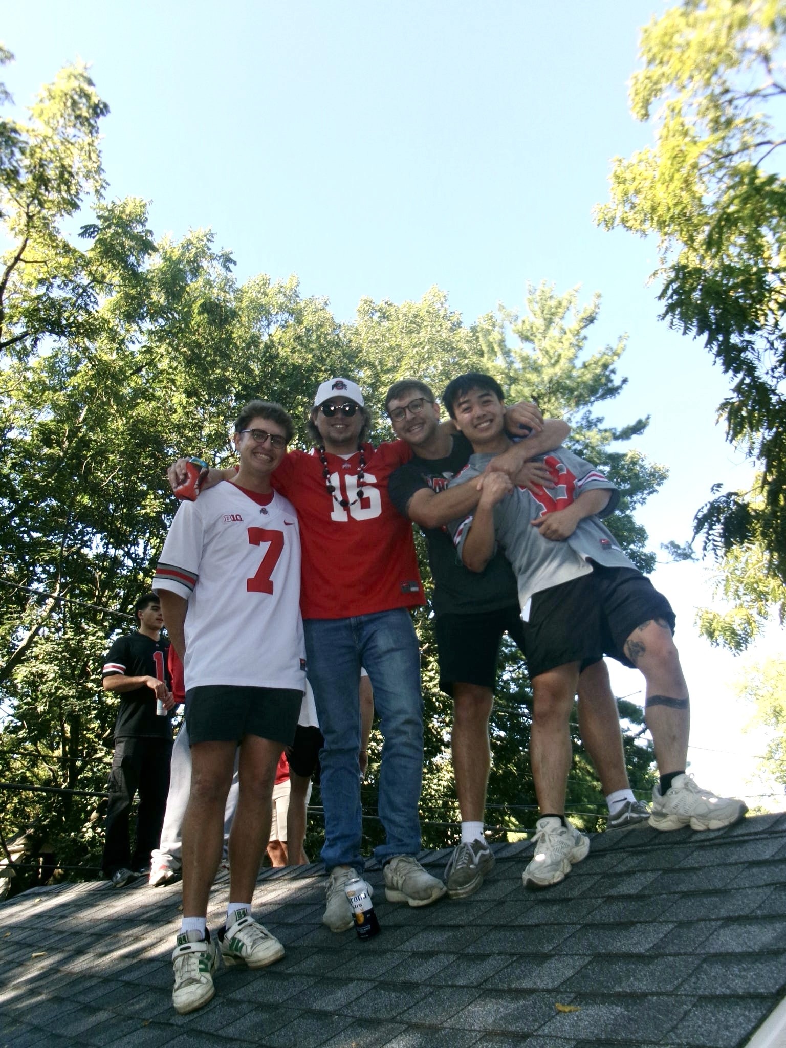 A close-up of a hand wearing multiple decorative rings against a blue background.