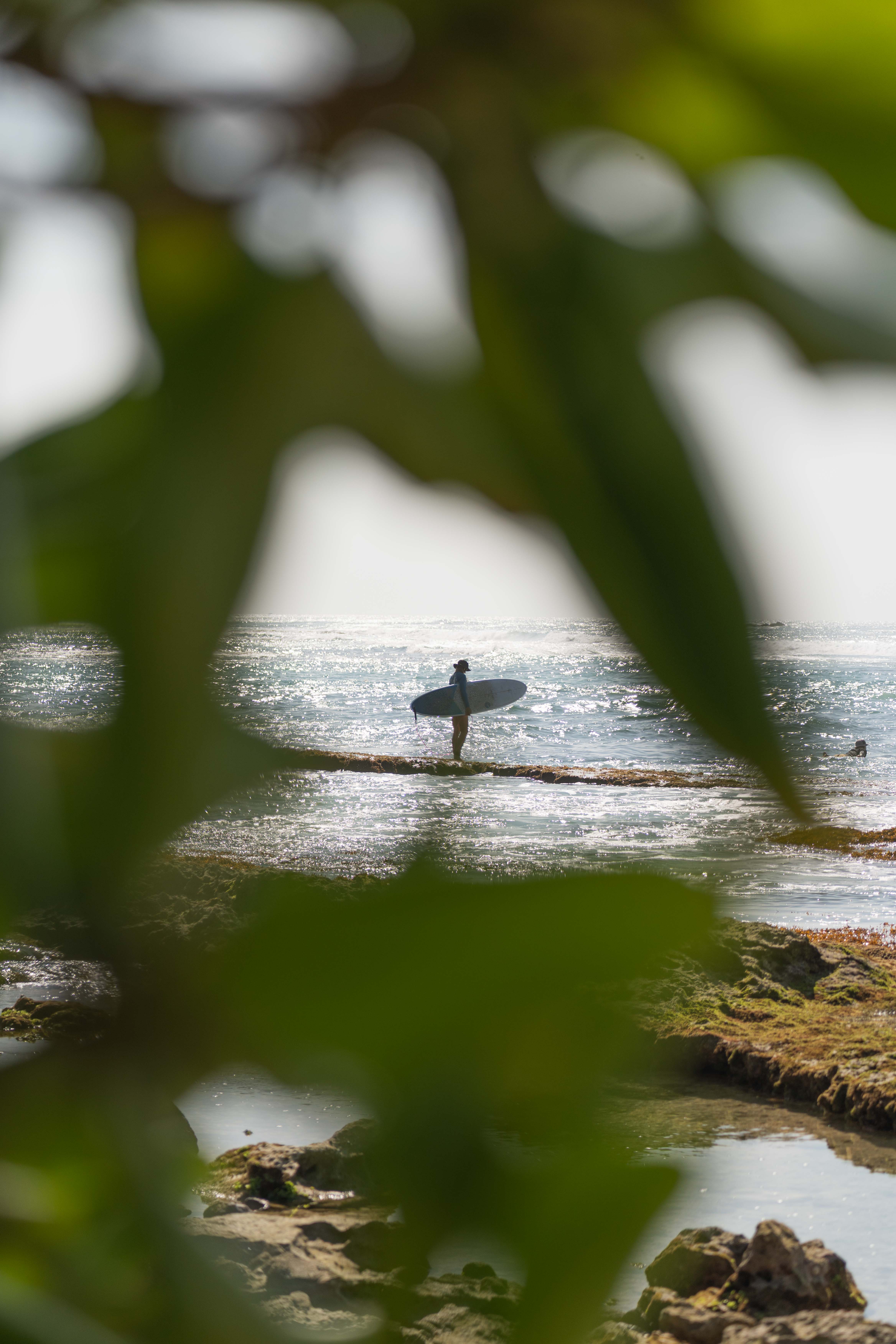 Surfer on the beach about to get into the water