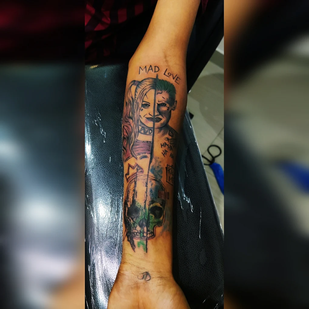 Colour Joker and Harley Quinn realism realism forearm tattoo with skull and Mad Love, inked at Fred’s Tattoo Studio, one of the best tattoo places in Bangalore.