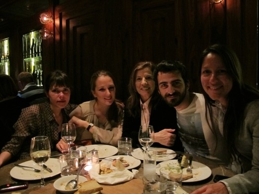 A photo of a group of people sitting at a restaurant table.