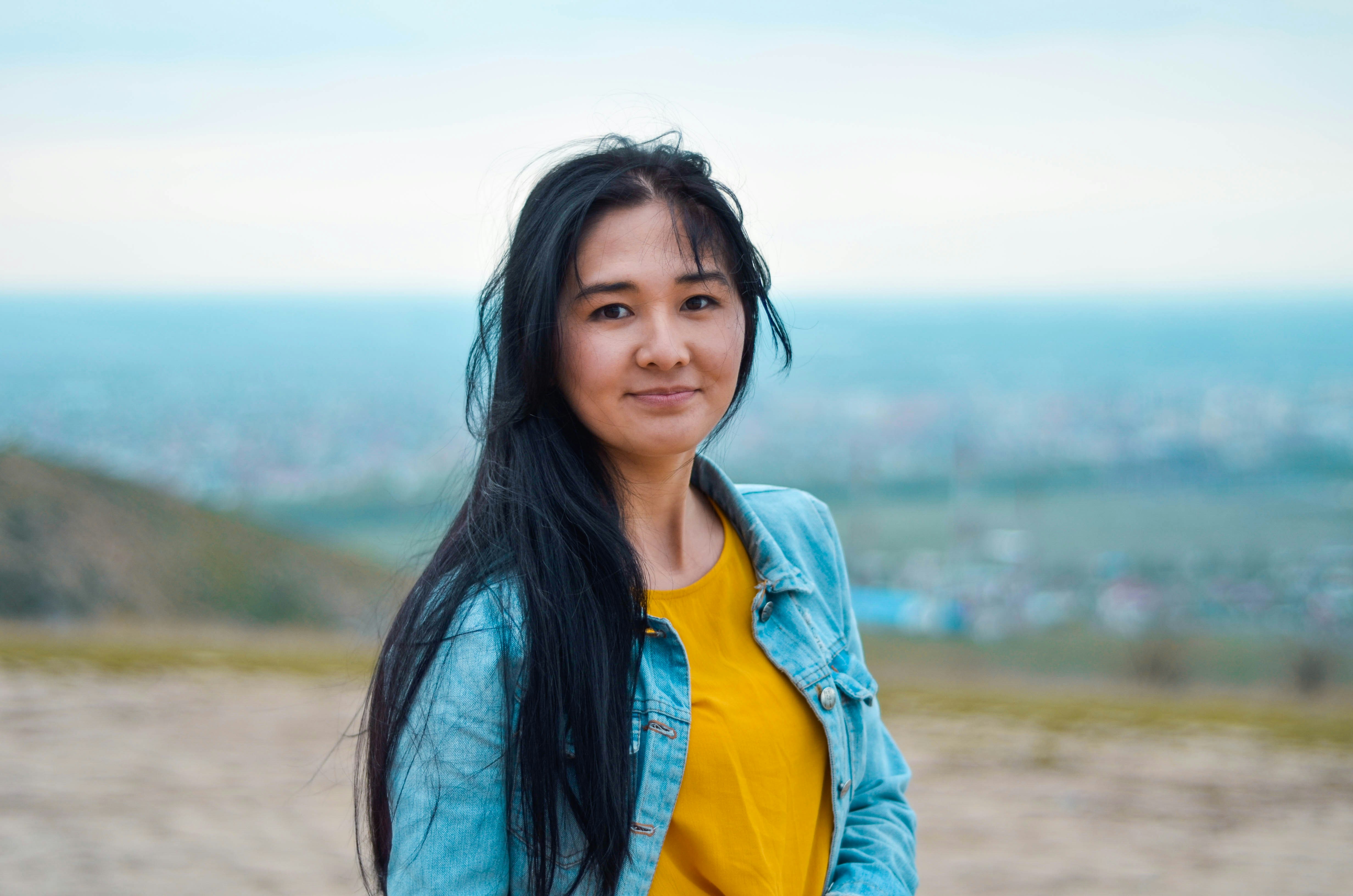 woman wearing blue denim jacket with yellow shirt