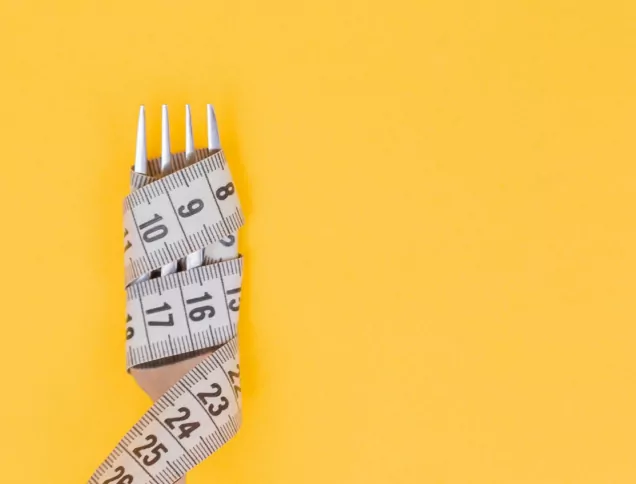 Measuring tape wrapped around a silver fork