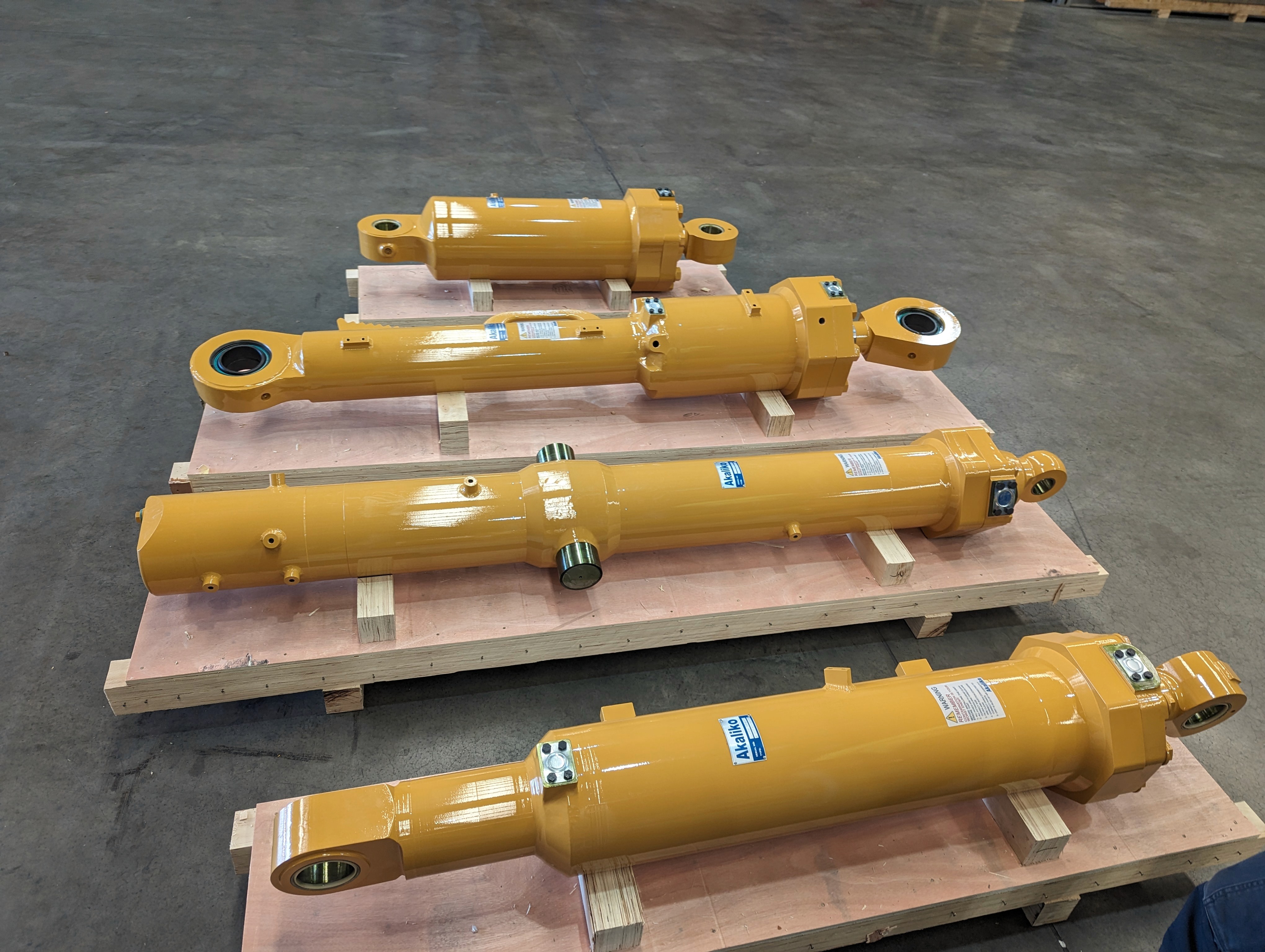 Aerial view of a hydroelectric dam spanning a turquoise river surrounded by dense forest and winding roads
