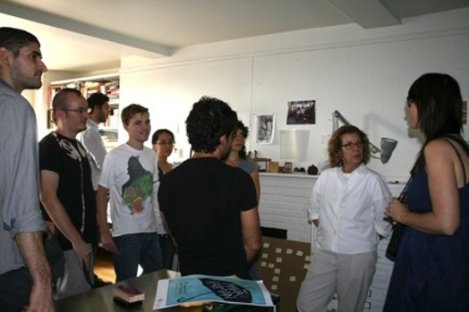 A photo of a group of students listening to a lecture given by a teacher.