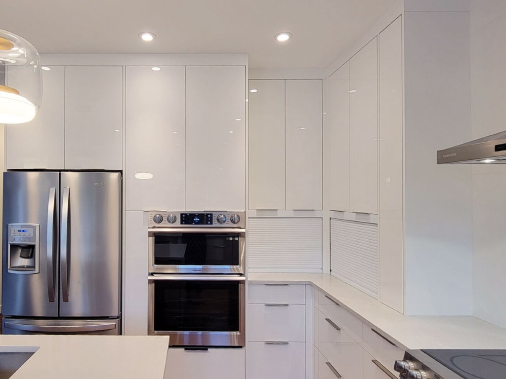 Image of Modern kitchen design with white cabinets, stainless steel appliances, and layout design by KHD Homes.