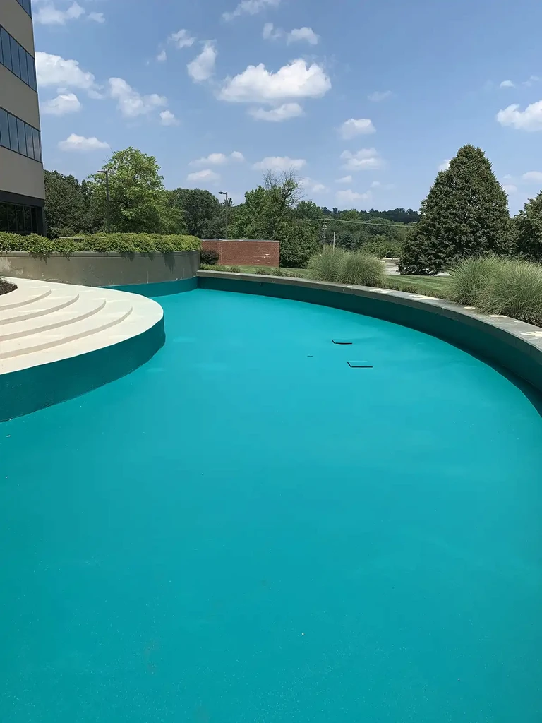 Photo of a fountain basin coated in Rub-R-Wall waterproofing coating to prevent water from seeping into the concrete