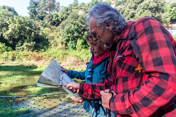 Older couple reviewing a map while planning their next steps before retirement.