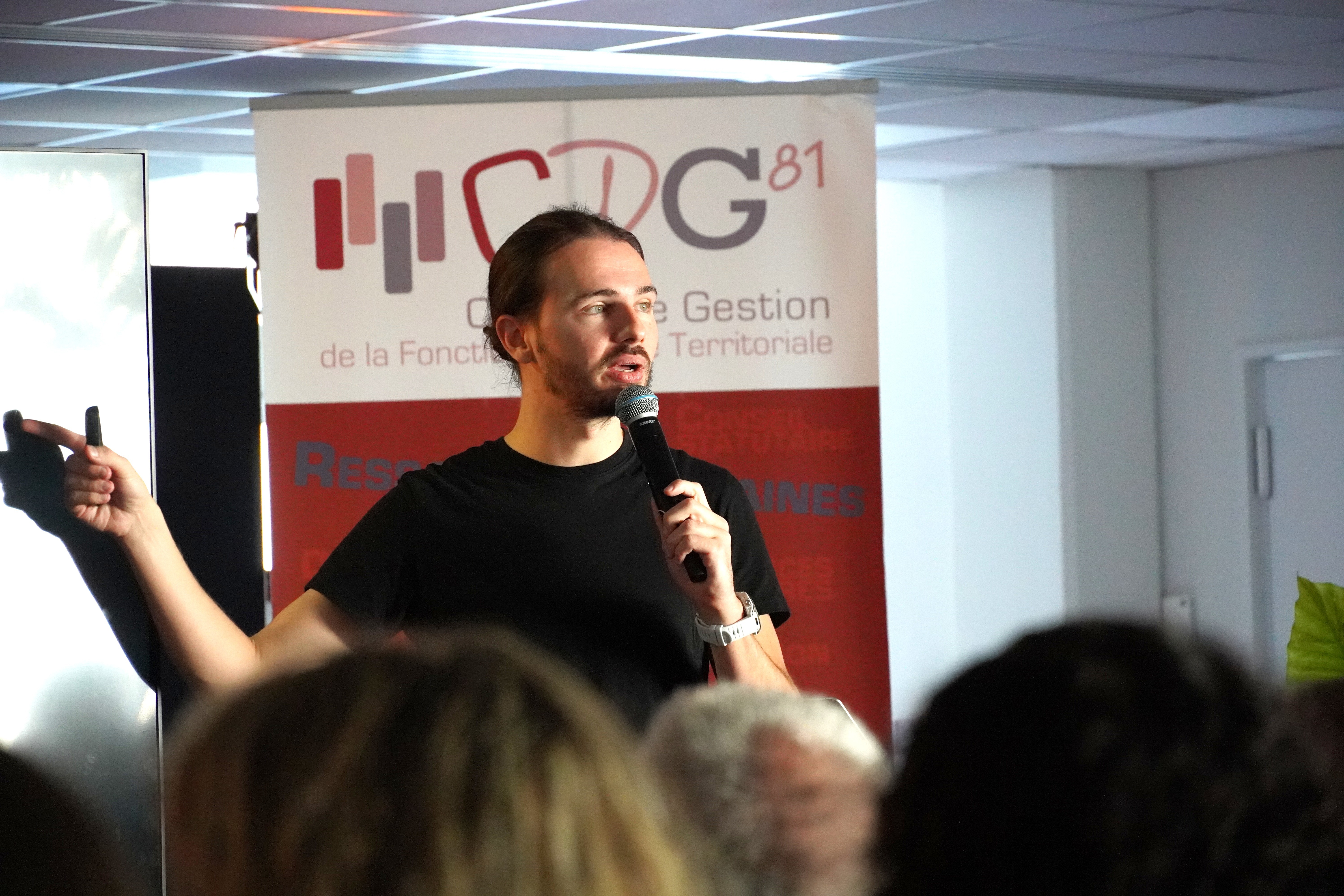 Film clapperboard in focus with glowing orange background, misty street, and silhouettes of people and lights; conveys mystery and anticipation.