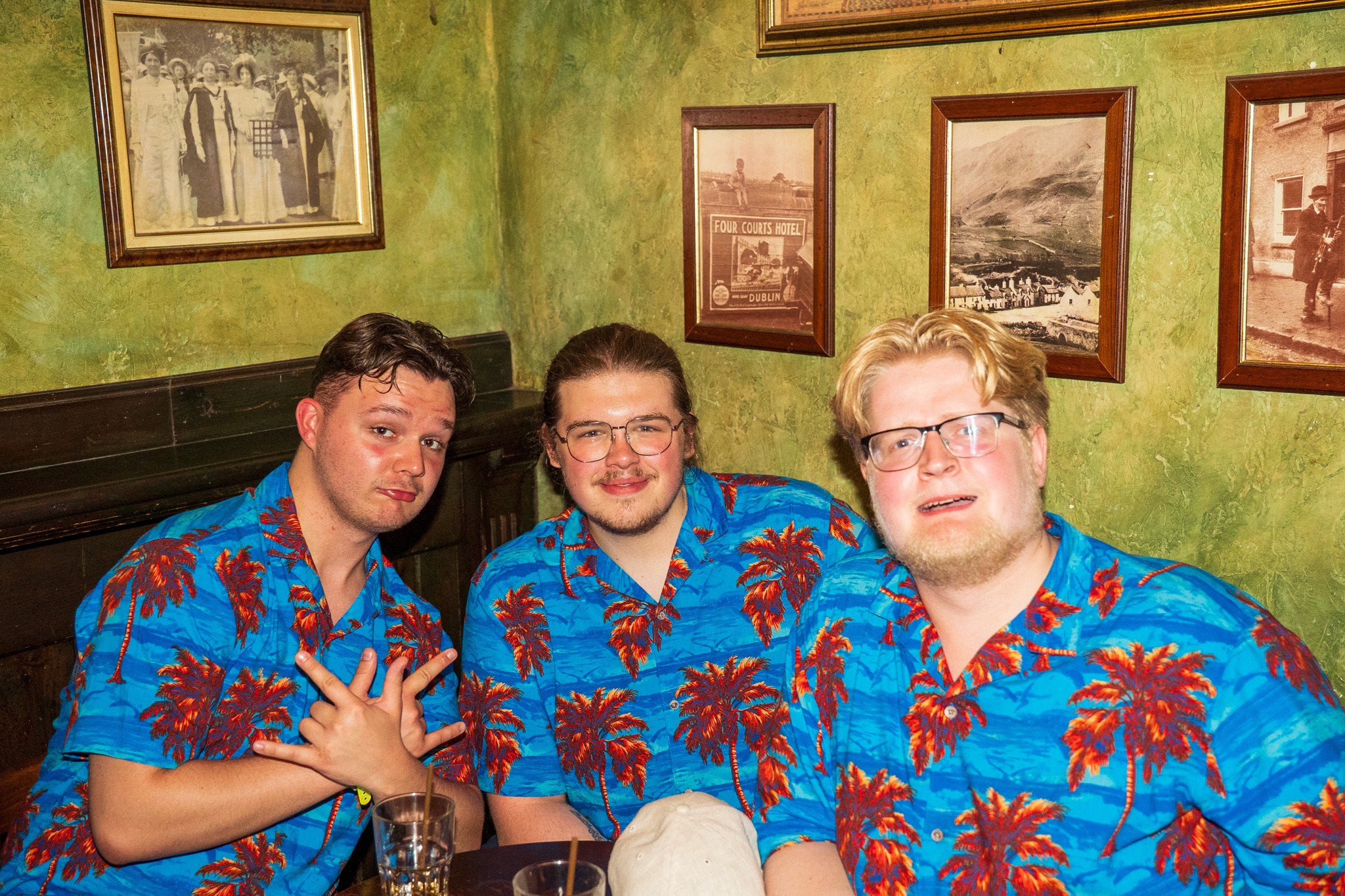 Group of friends wearing matching tropical shirts during a themed pub crawl in Nice showing fun costumes and social nightlife atmosphere in the French Riviera