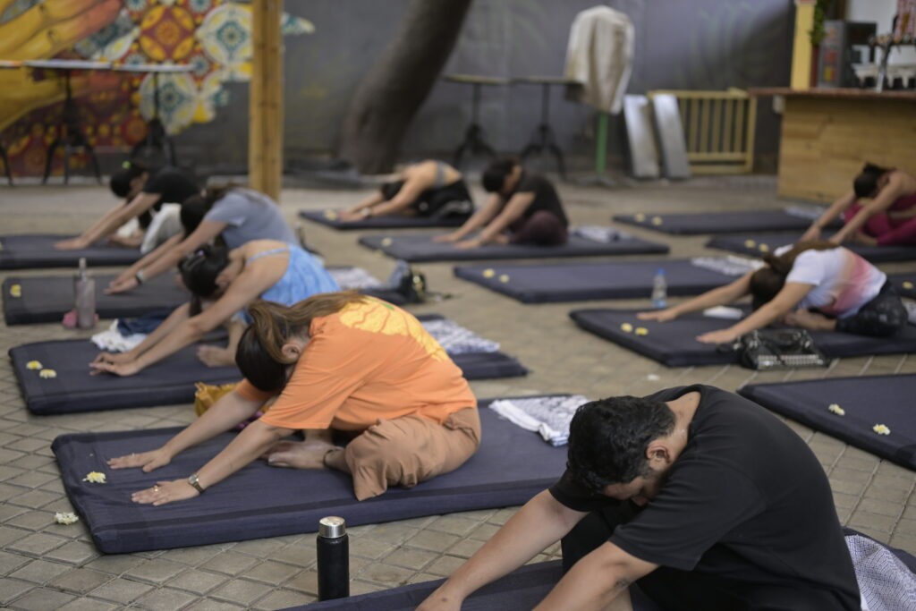 Participants practicing restorative yoga during an immersive wellness and sound meditation session at High Spirits Pune