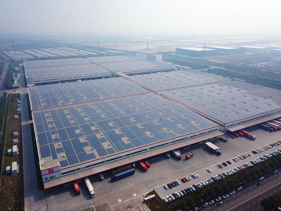 Modern logistics facility with solar panels, representing sustainable investments in logistics real estate