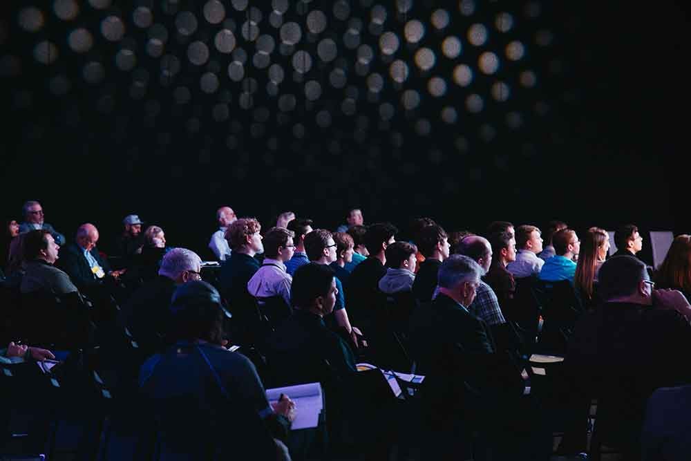 An image of a crowd sitting at a corporate event