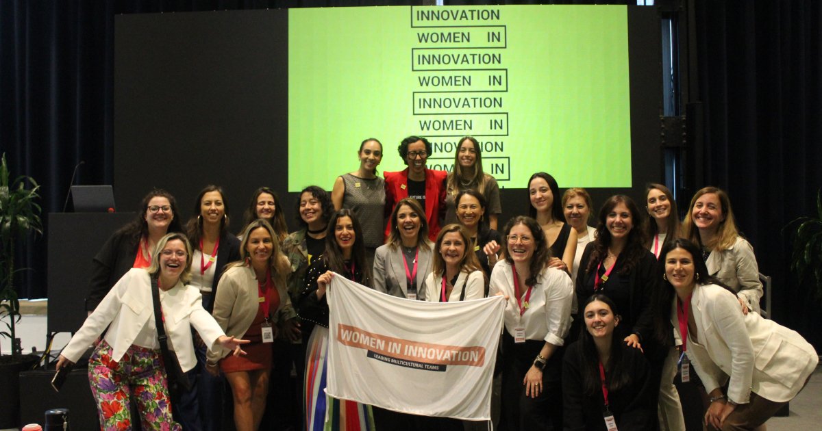 Group of women holding up a Women in Innovation banner