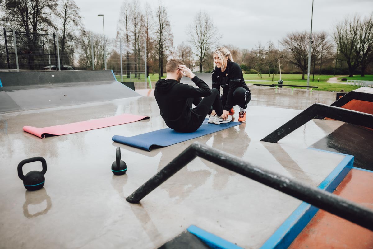 Kyra guiding client while working legs