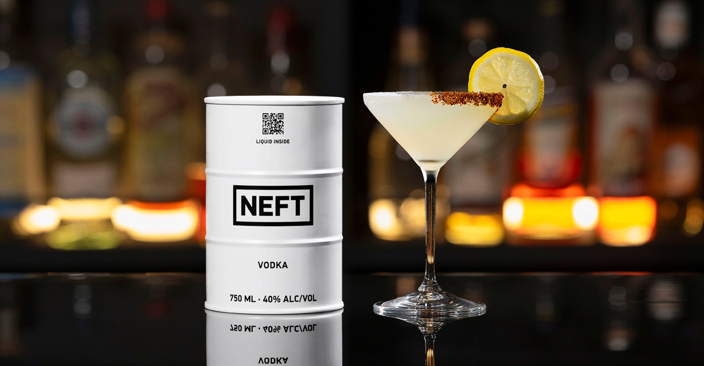 A NEFT Barrel and a glass of Lemon Drop on a bar counter.