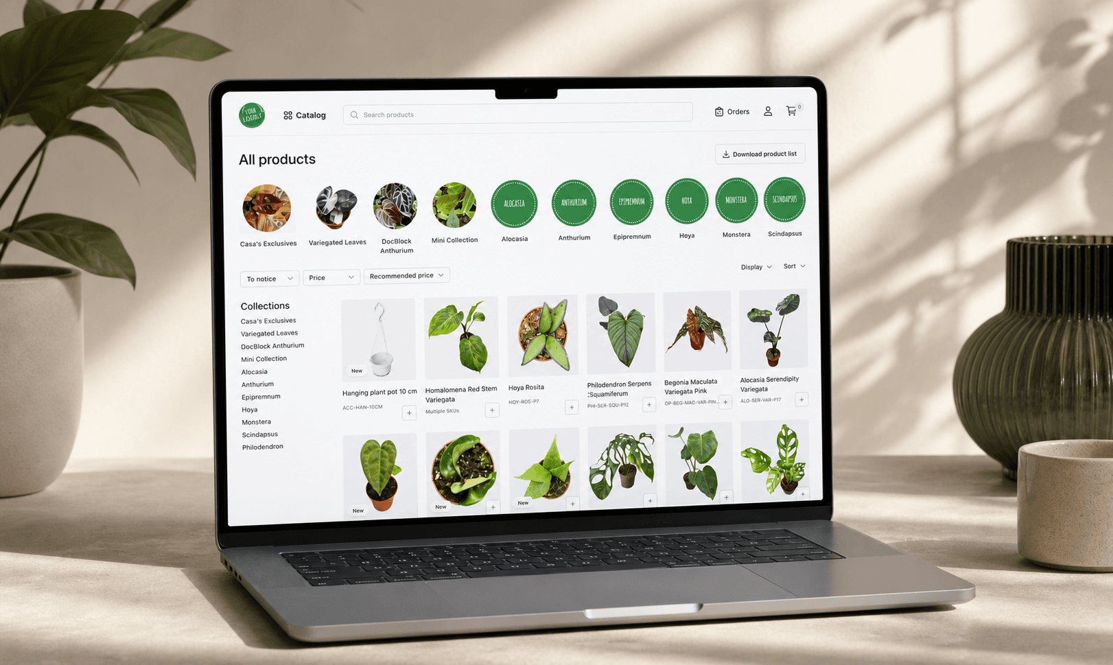 Laptop displaying a branded B2B wholesale portal powered by Orderchamp Cloud, featuring a plant product catalog in a modern workspace setting with natural styling and soft lighting