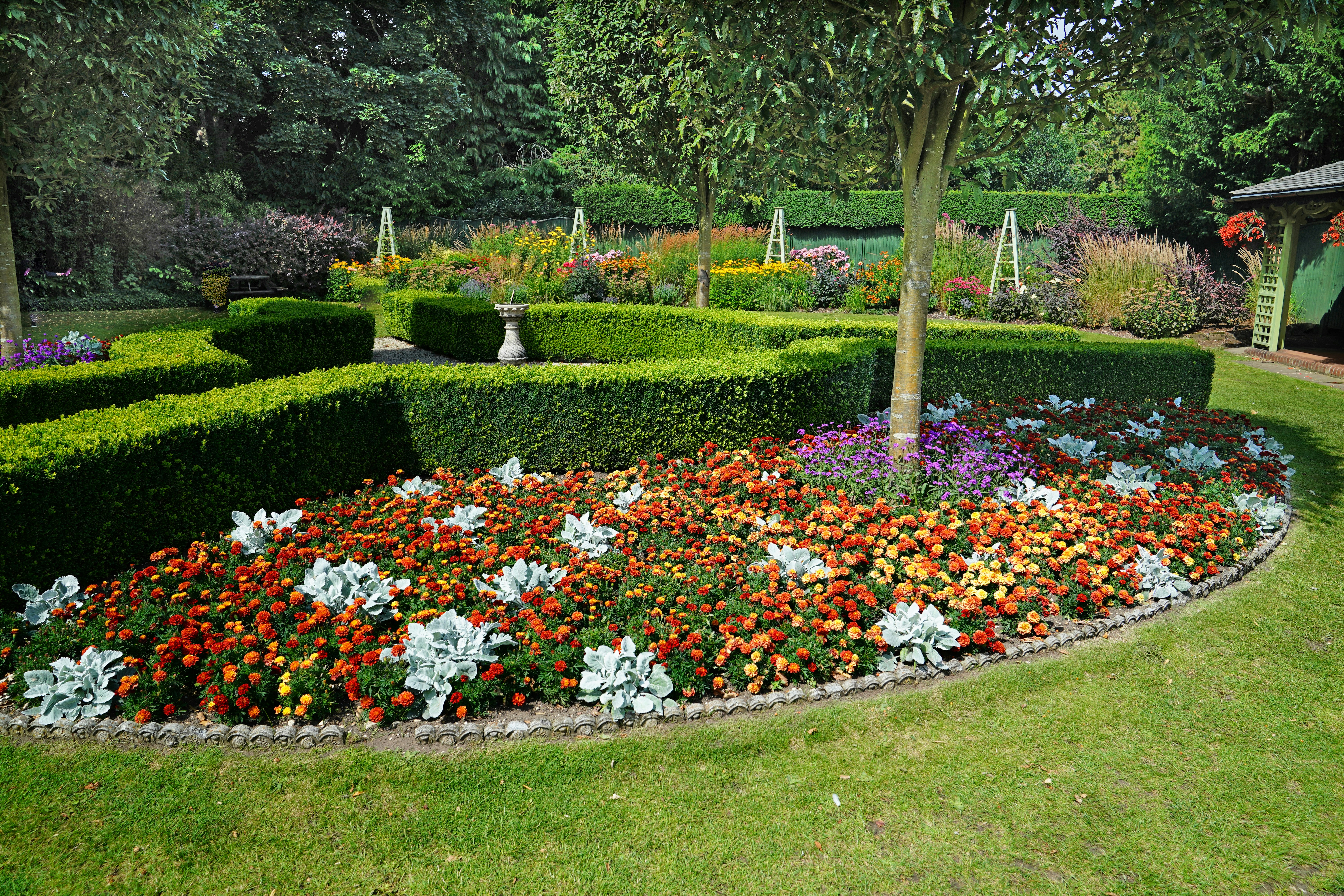 a garden with flowers with Butchart Gardens in the background