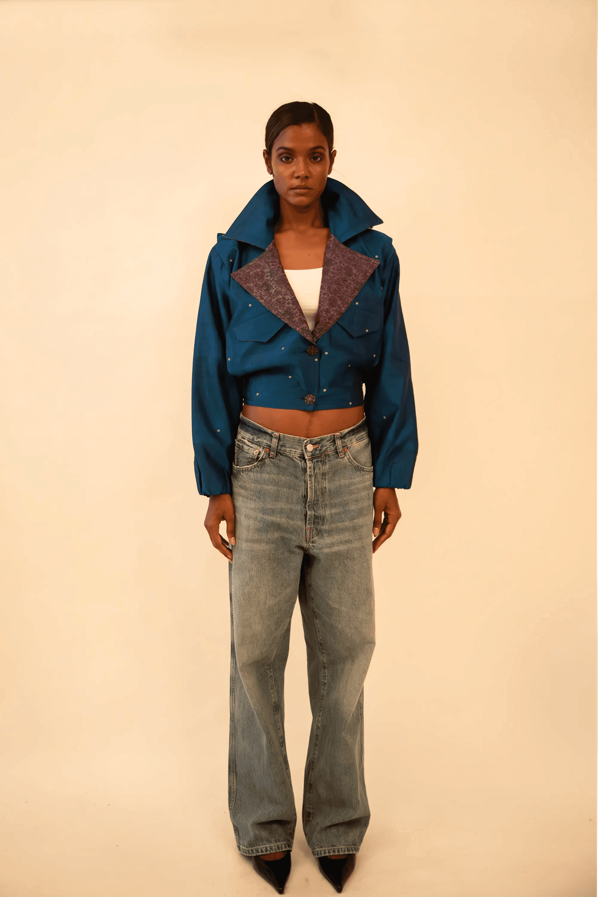 AMBR is our one-of-a-kind cropped two-toned silk brocade&nbsp; bomber jacket, handcrafted by skilled artisans in-house using a vintage silk saris