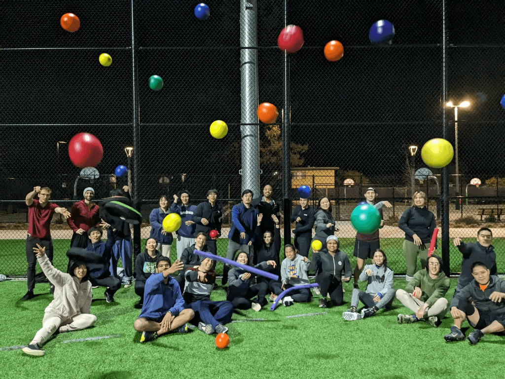 Bay Area Dodgeball And Similar Sports (BADASS) group photo throwing dodgeballs toward the camera