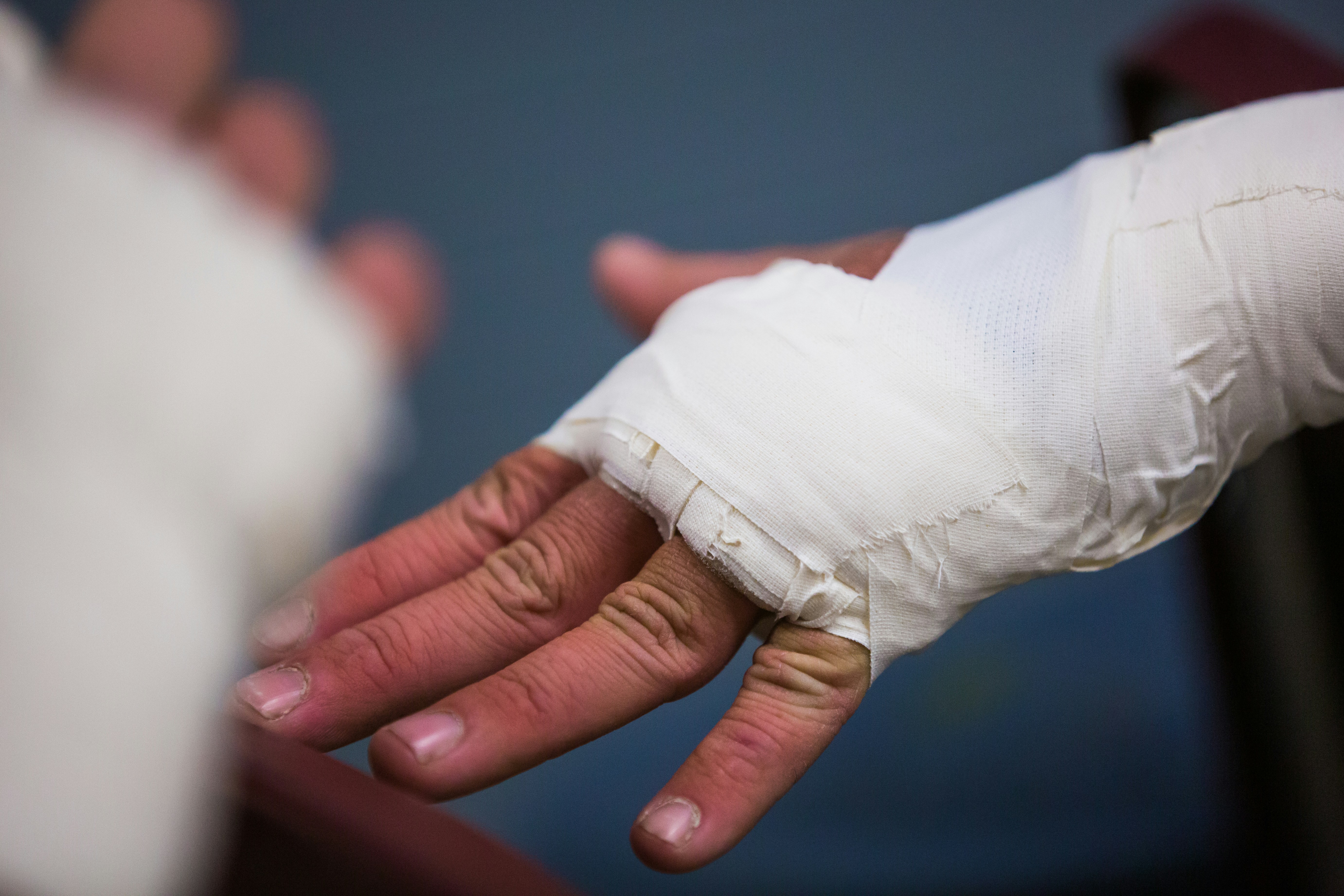 person with white bandage on hand