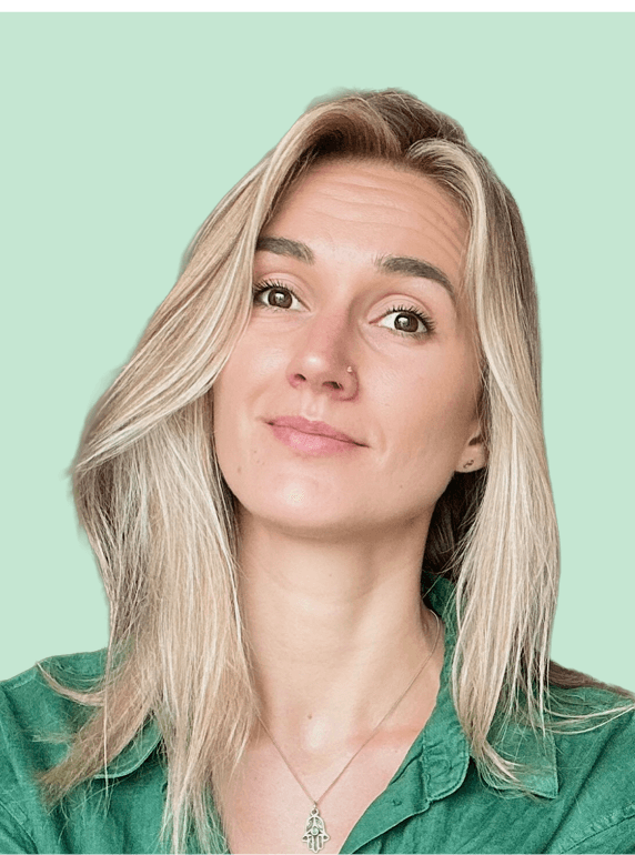 Portrait of a laughing person with curly hair wearing a white shirt