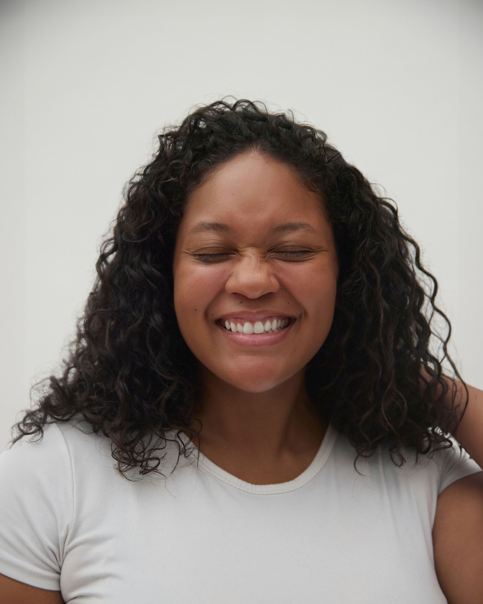 Woman with red hair covering mouth with hair