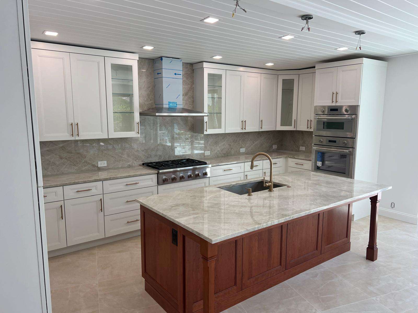 White Shaker Cabinets with Taj Mahal quartzite countertops