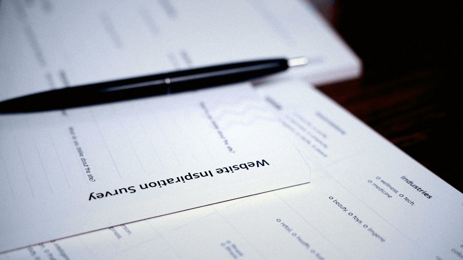 Pen resting on a printed form ready to be filled in