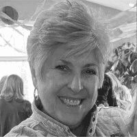 Female with short hair smiling towards the camera