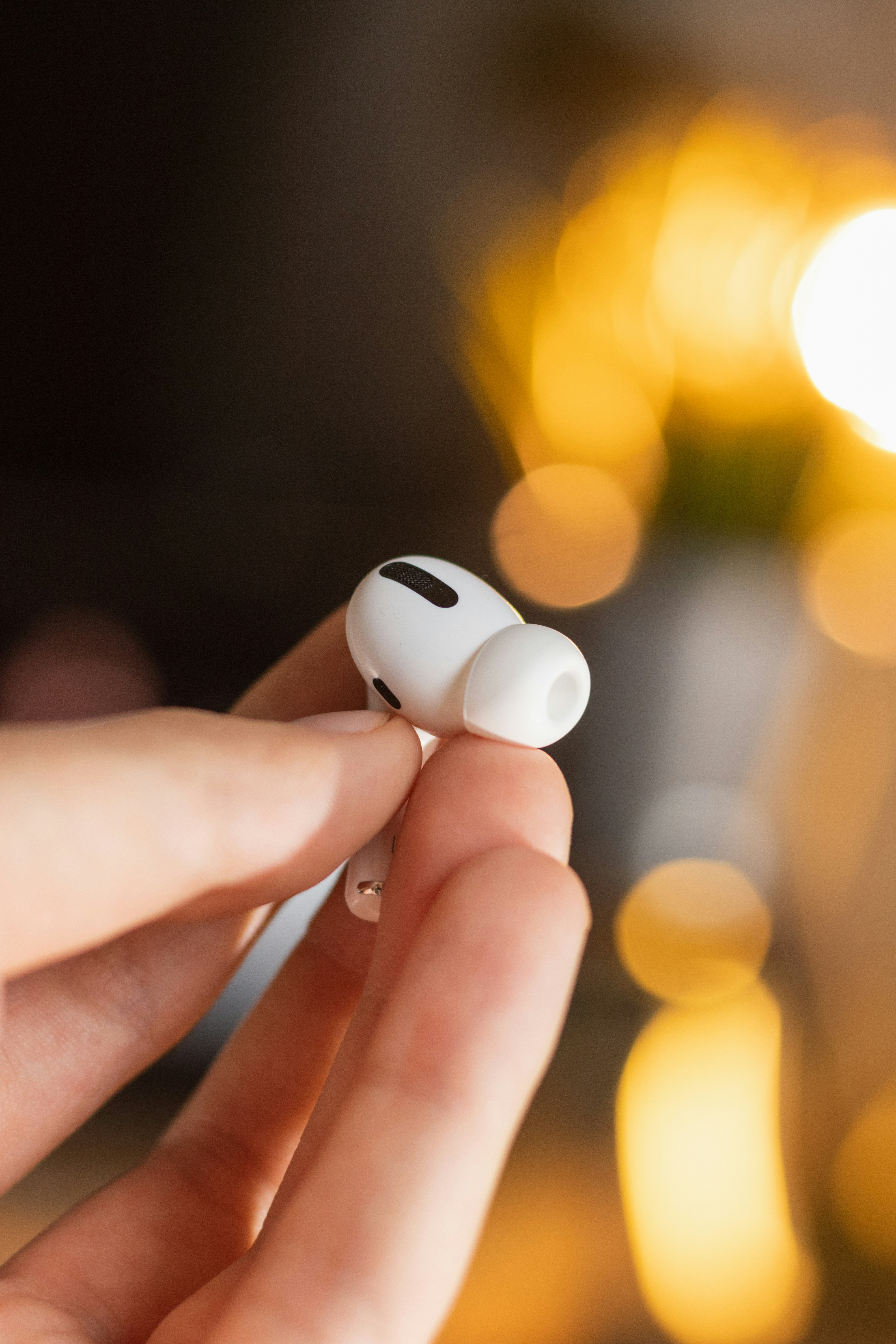 white apple earpods on persons hand